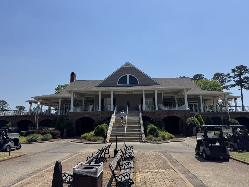 The clubhouse at RTJ Golf Trail Grand National, Opelika, Alabama, with golf carts parked out front